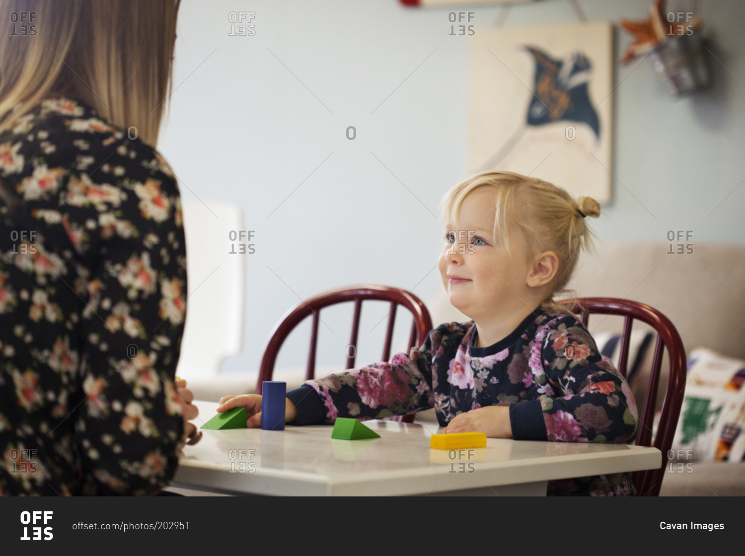 Young girl looking at teacher in preschool