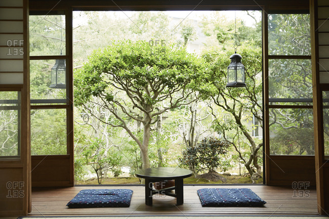 Floor cushions and a table inside a traditional Japanese home