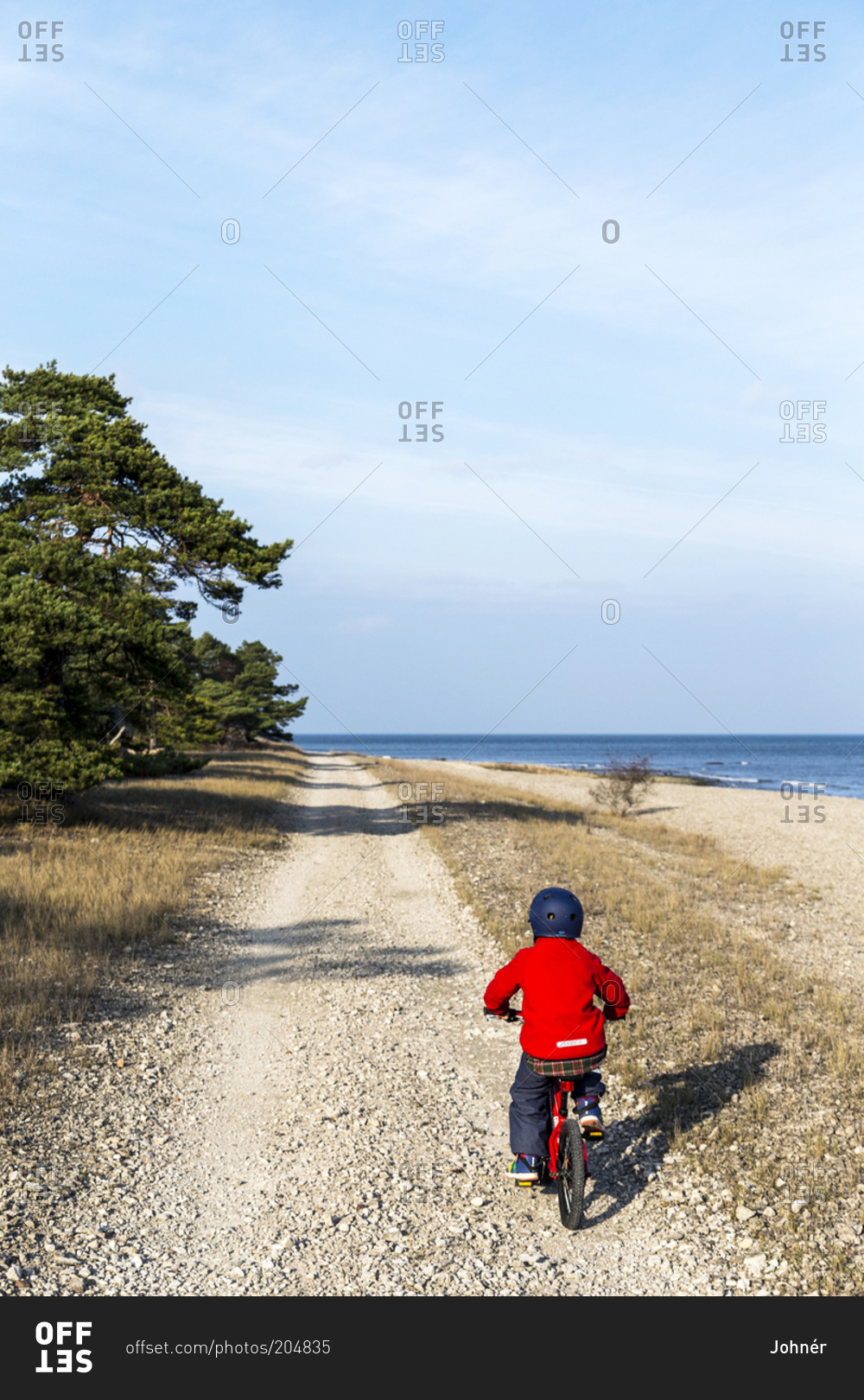 Boy on bicycle on dirt road
