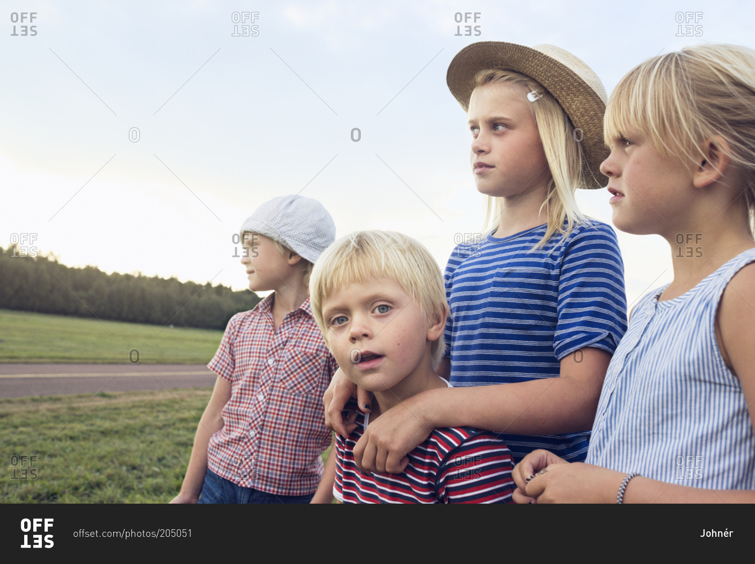 Group of blond children standing at the side of the world
