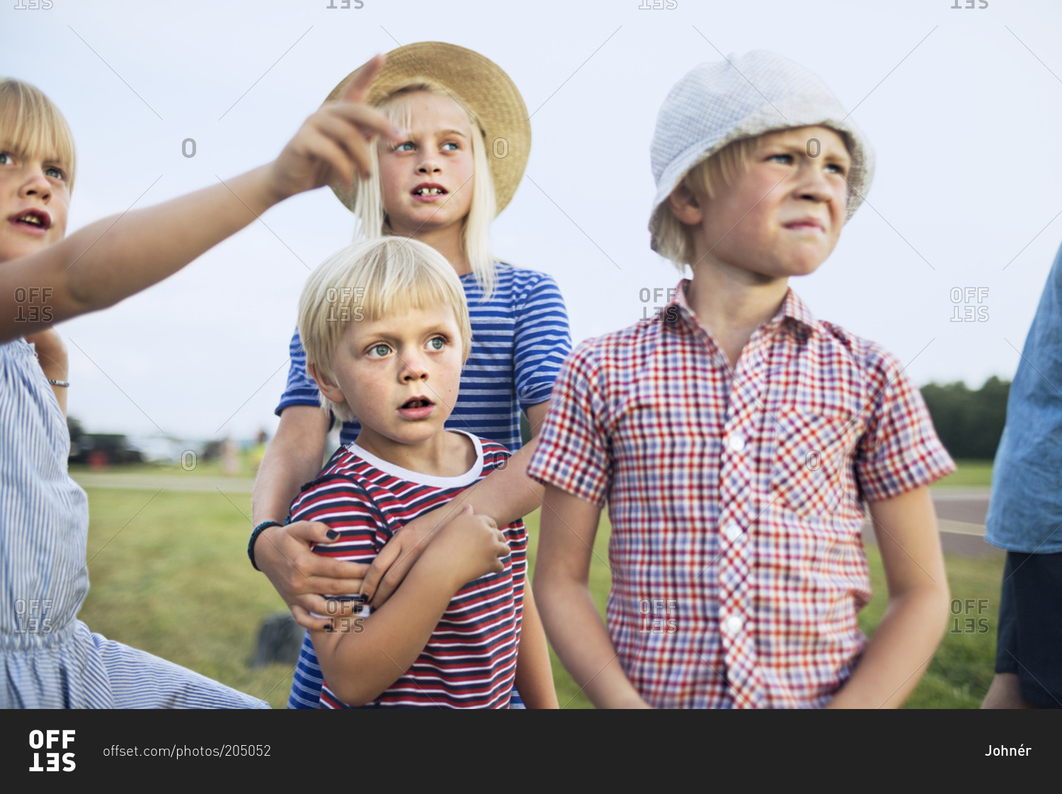 Group of blond children looking at something in the distant