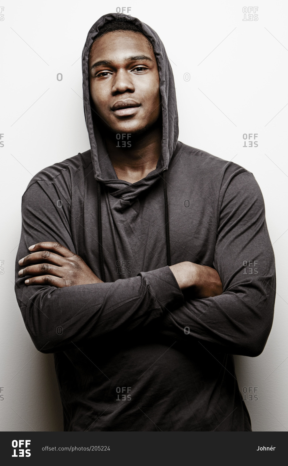 Download Portrait Of Young Man Wearing Hoodie With His Arms Crossed Stock Photo Offset