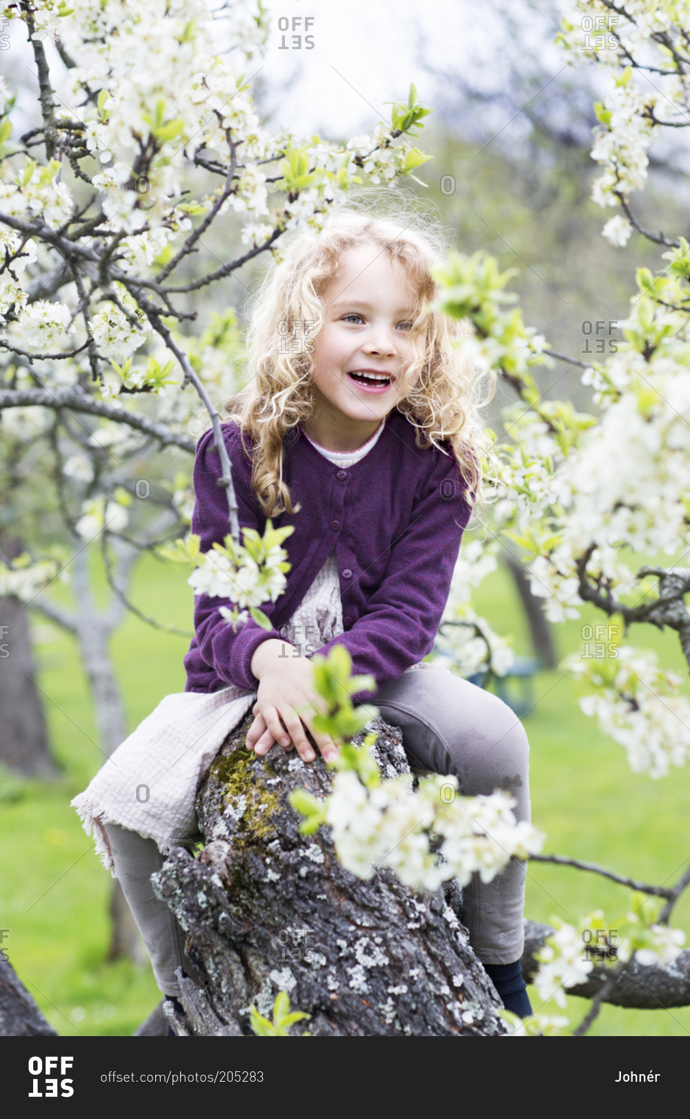 Smiling girl near blooming tree