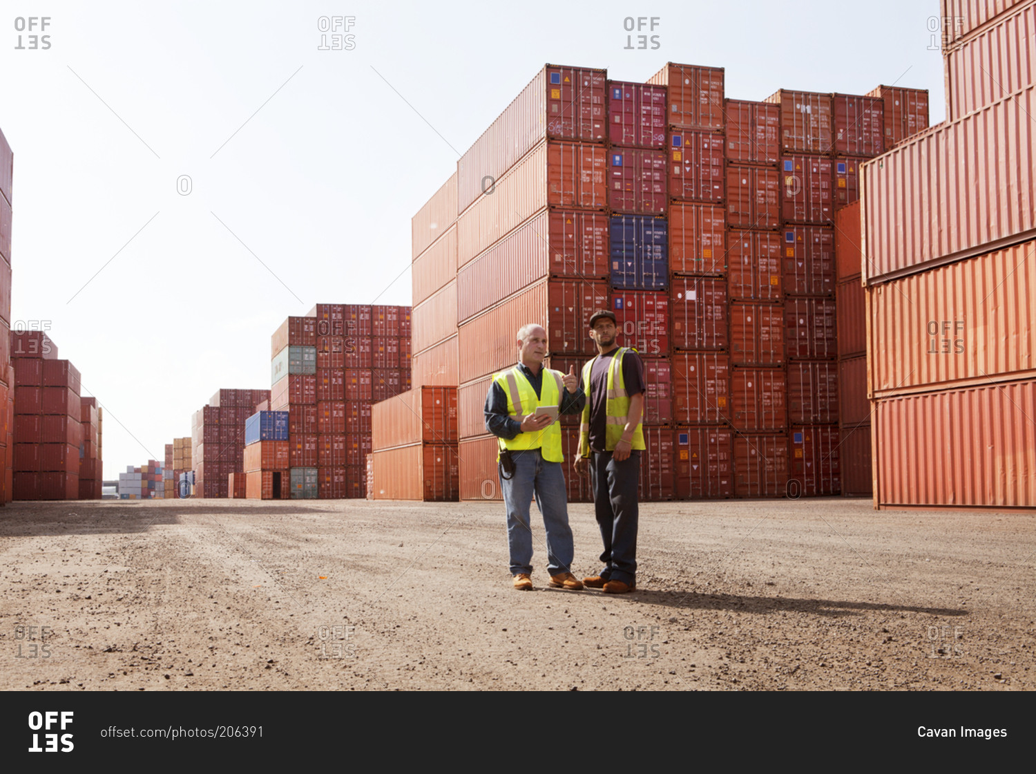 Freight yard employees inspecting cargo