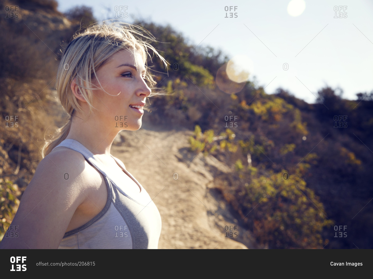 Woman standing confidently during trail workout