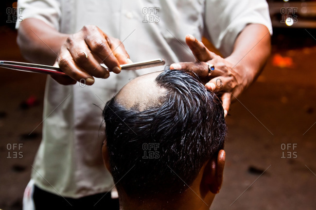 Man getting head shaved during kavadi festival