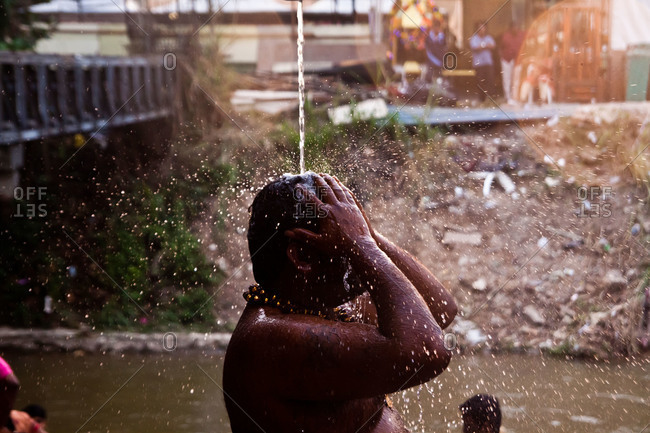 Man showers and prays during kavadi festival