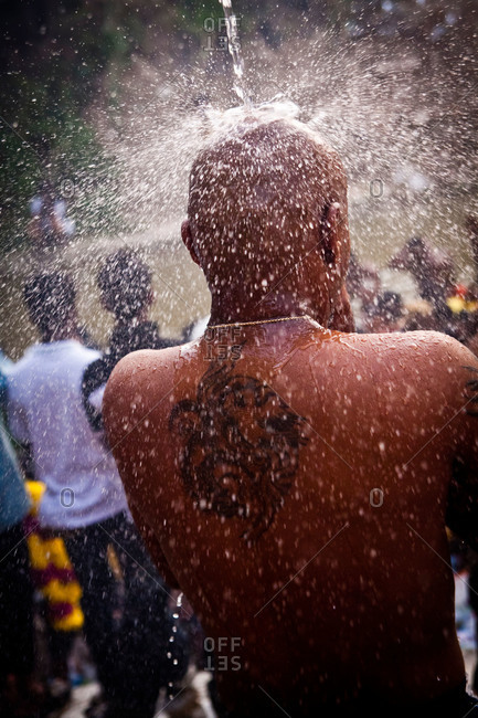 Man showers and prays during Malaysia festival