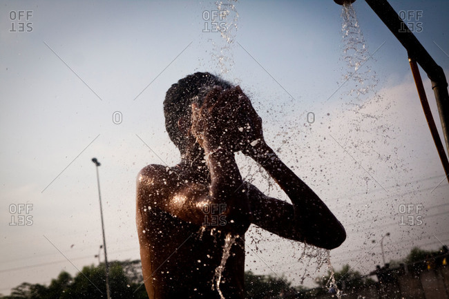 A man showers and prays in Malaysia festival
