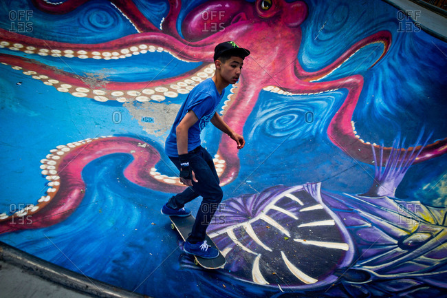Brussels, Belgium - June 2, 2013: Teen riding board in skate park