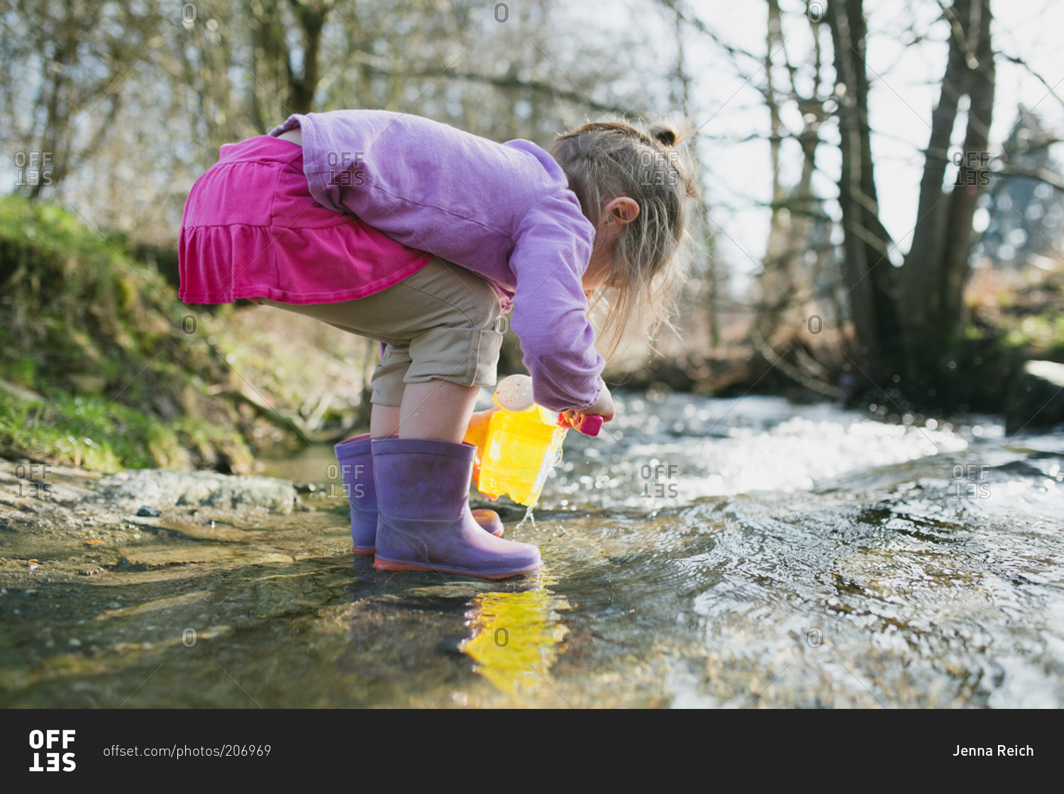 A little girl plays in a stream
