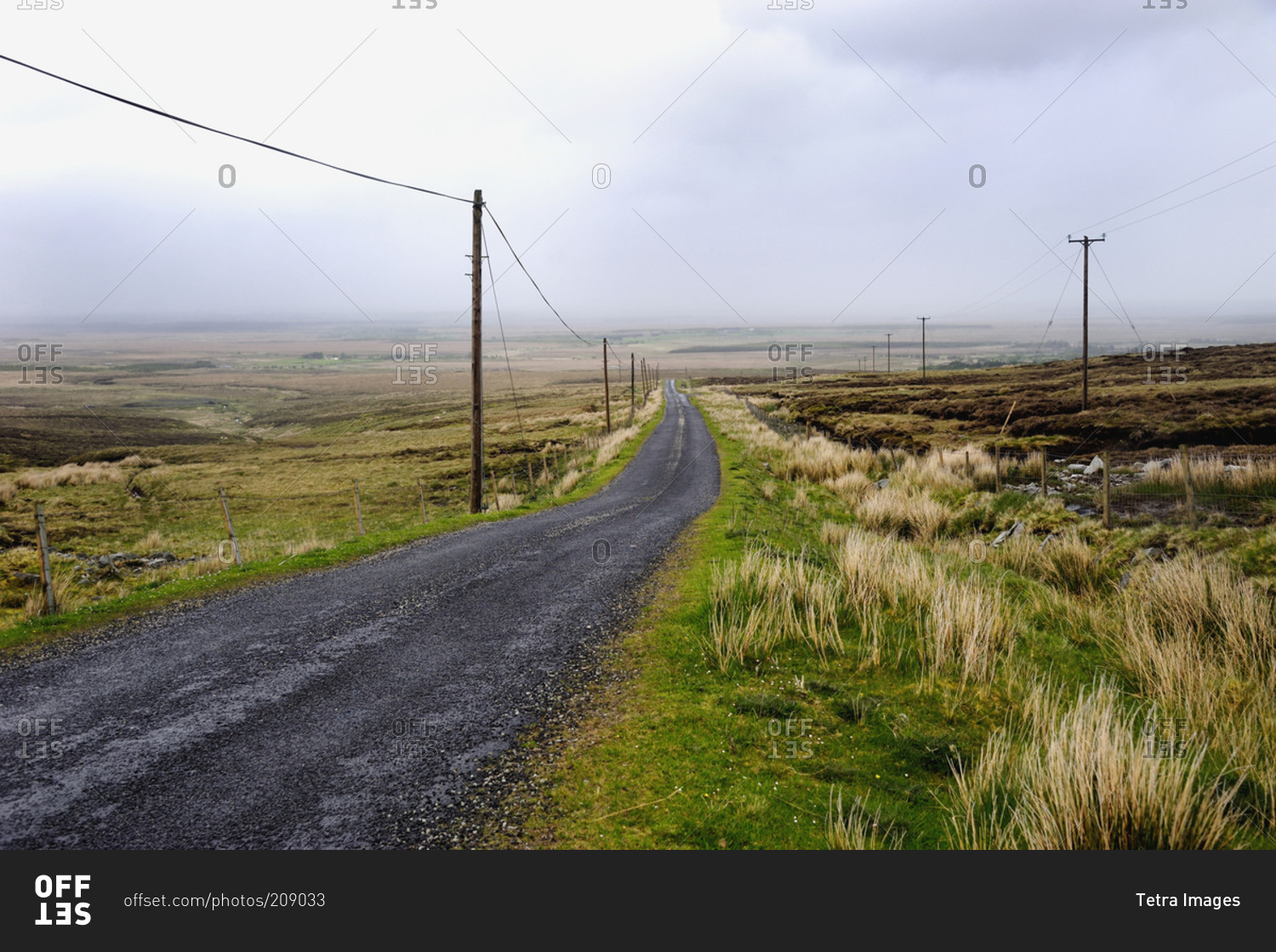 Rural country road runs through barren countryside