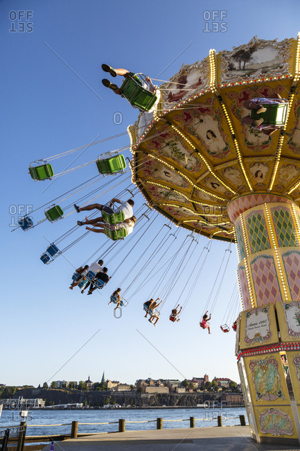 Djurgarden, Stockholm, Sweden - July 25, 2014: People on ride in amusement park in Sweden