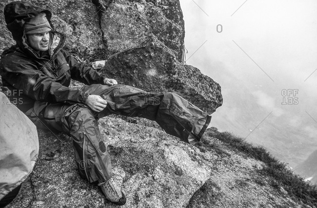 Climber prepares for rain in Canadian mountains