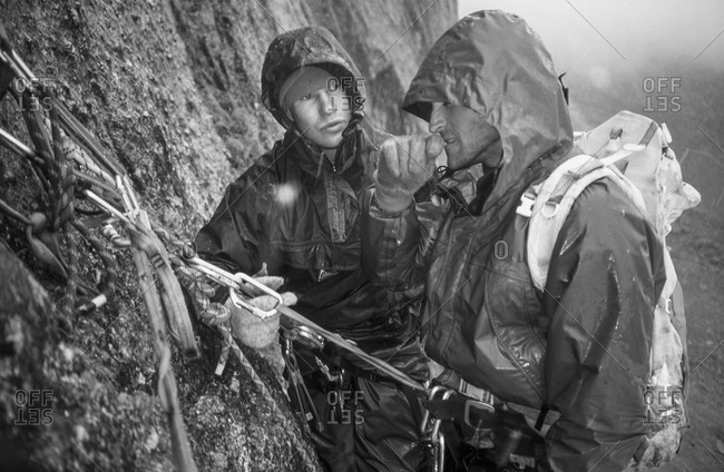 Climbers prepare to descend in rain storm in Canadian mountains