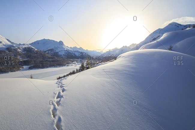Footprints marching towards the Maloja Pass in Graubunden, Switzerland