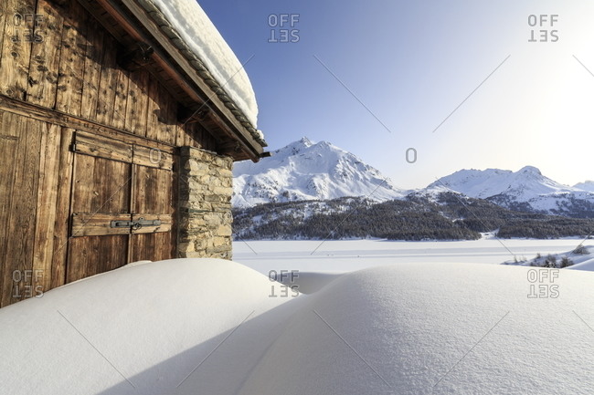 A cabin covered with snow at the Maloja Pass, Graubunden, Swiss Alps, Switzerland, Europe