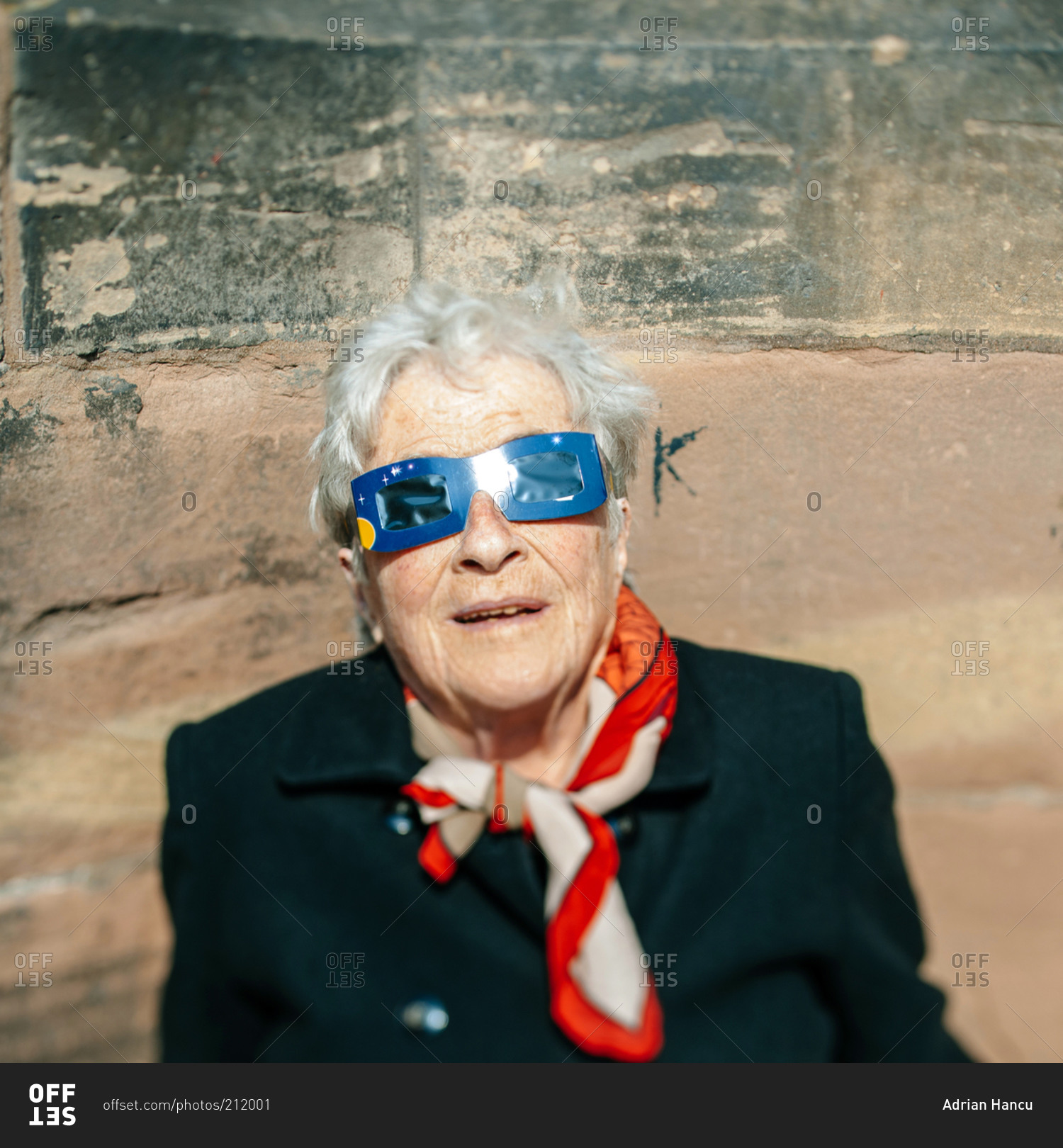 Strasbourg, France - March 20, 2015: Elderly woman watches a solar ...