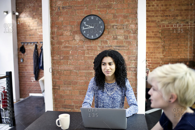 Woman using a laptop on a meeting