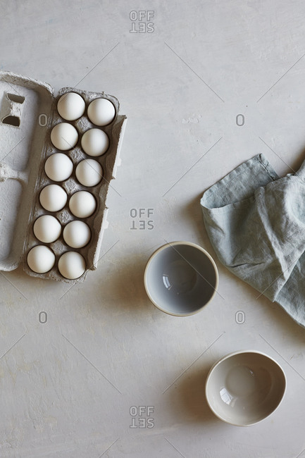 A dozen fresh eggs and bowls