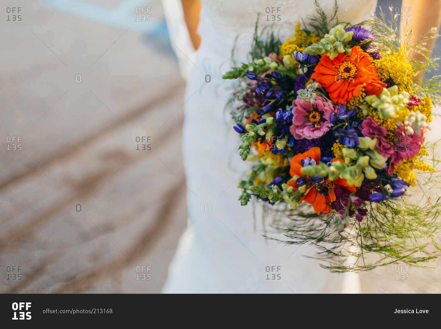 A bride carries a brightly colored bouquet