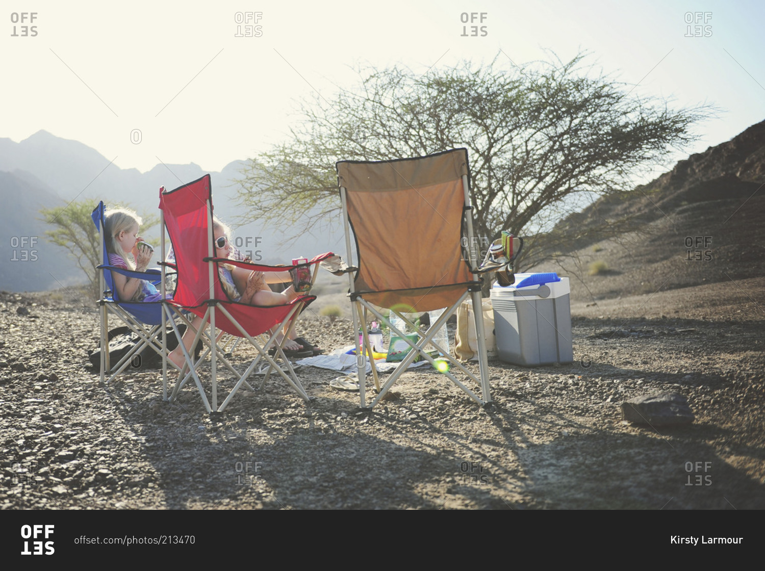 Young girls relaxing in camping chairs