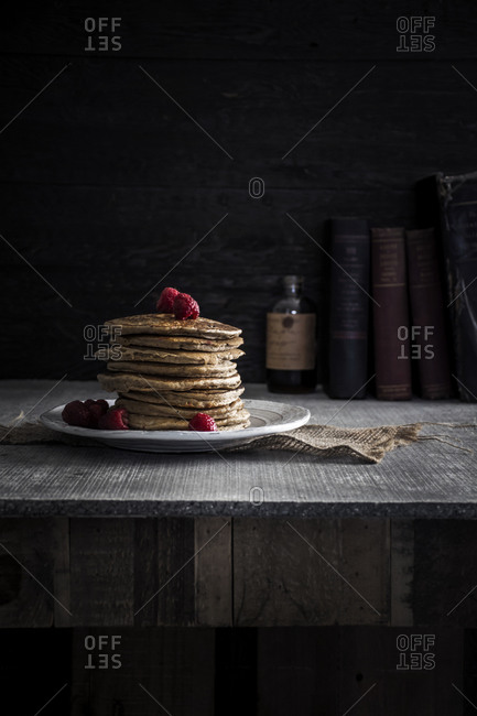 Raspberry pancakes served on a table