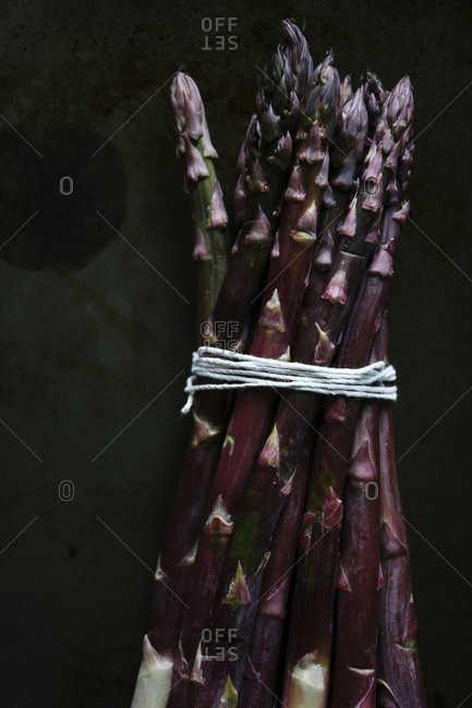 Bunch of purple asparagus on a baking sheet
