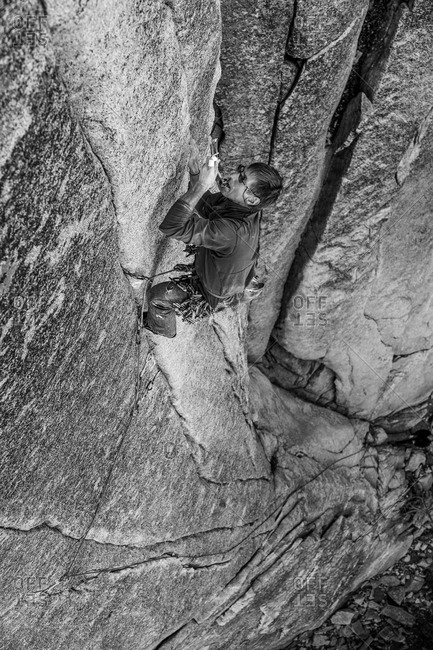 Climber struggles up a challenging cliff