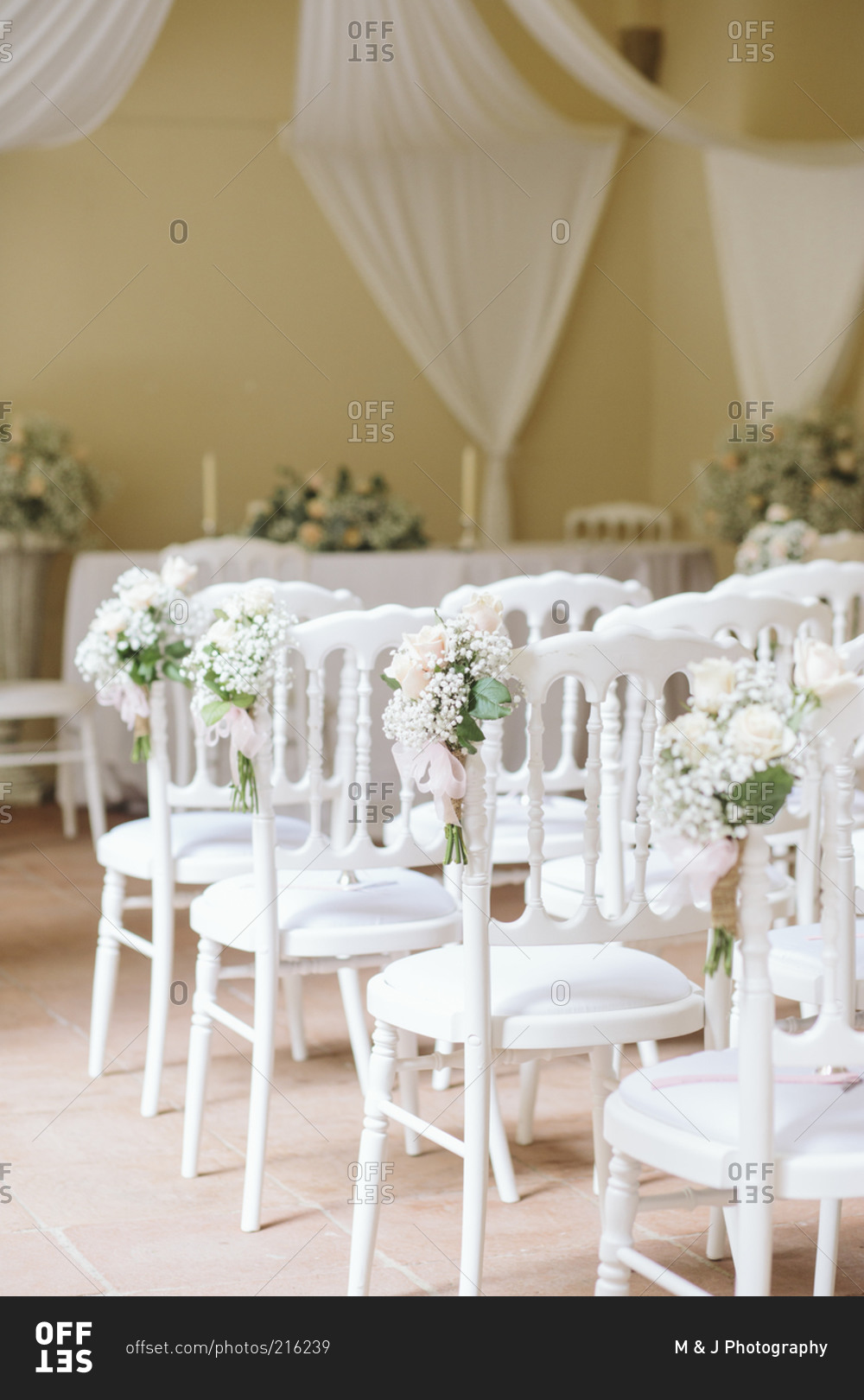 Chairs lined up with flowers for wedding