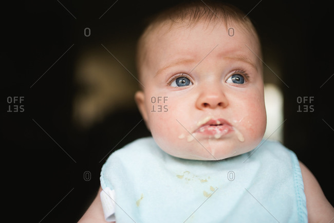 Portrait of infant with solid food on face