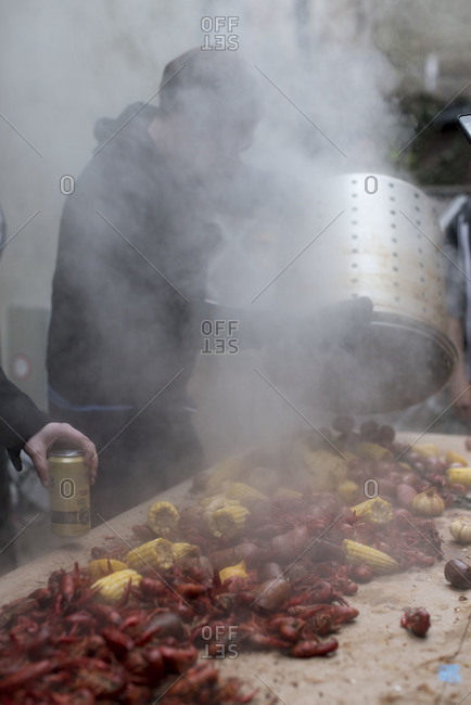Pouring steaming crayfish onto table