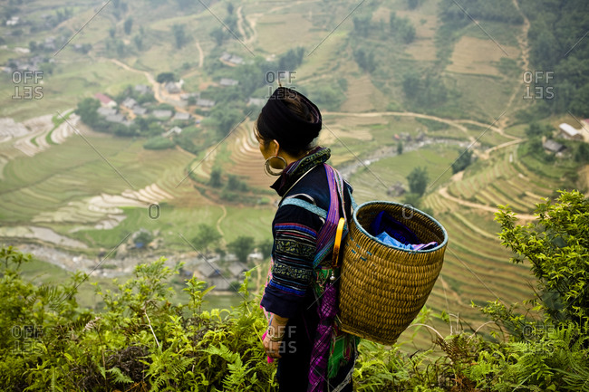 Black Hmong woman overlooking rice fields in Sapa, Vietnam