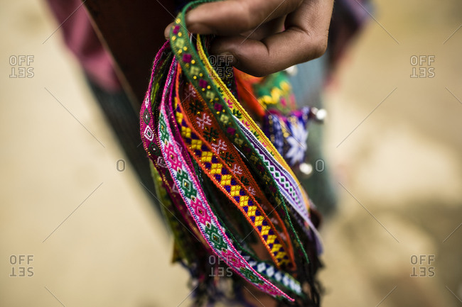 Hmong girl holds out bracelets for sale in Sapa, Vietnam