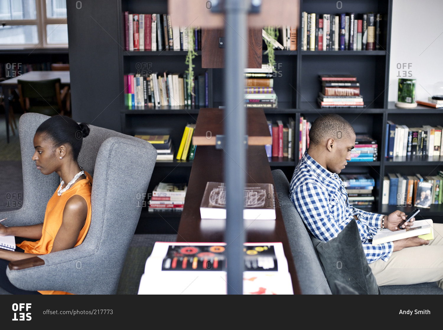 Two people work in a common space in an open office