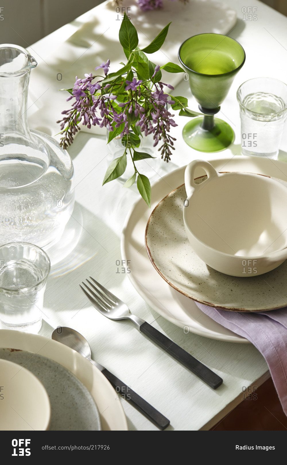A table setting with purple flowers