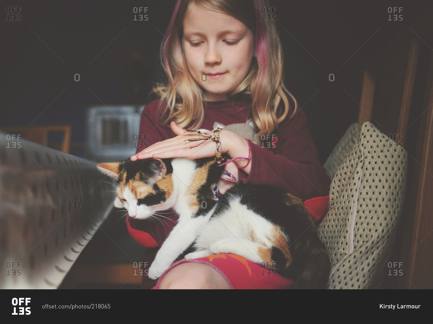 Blonde girl holding a tabby cat