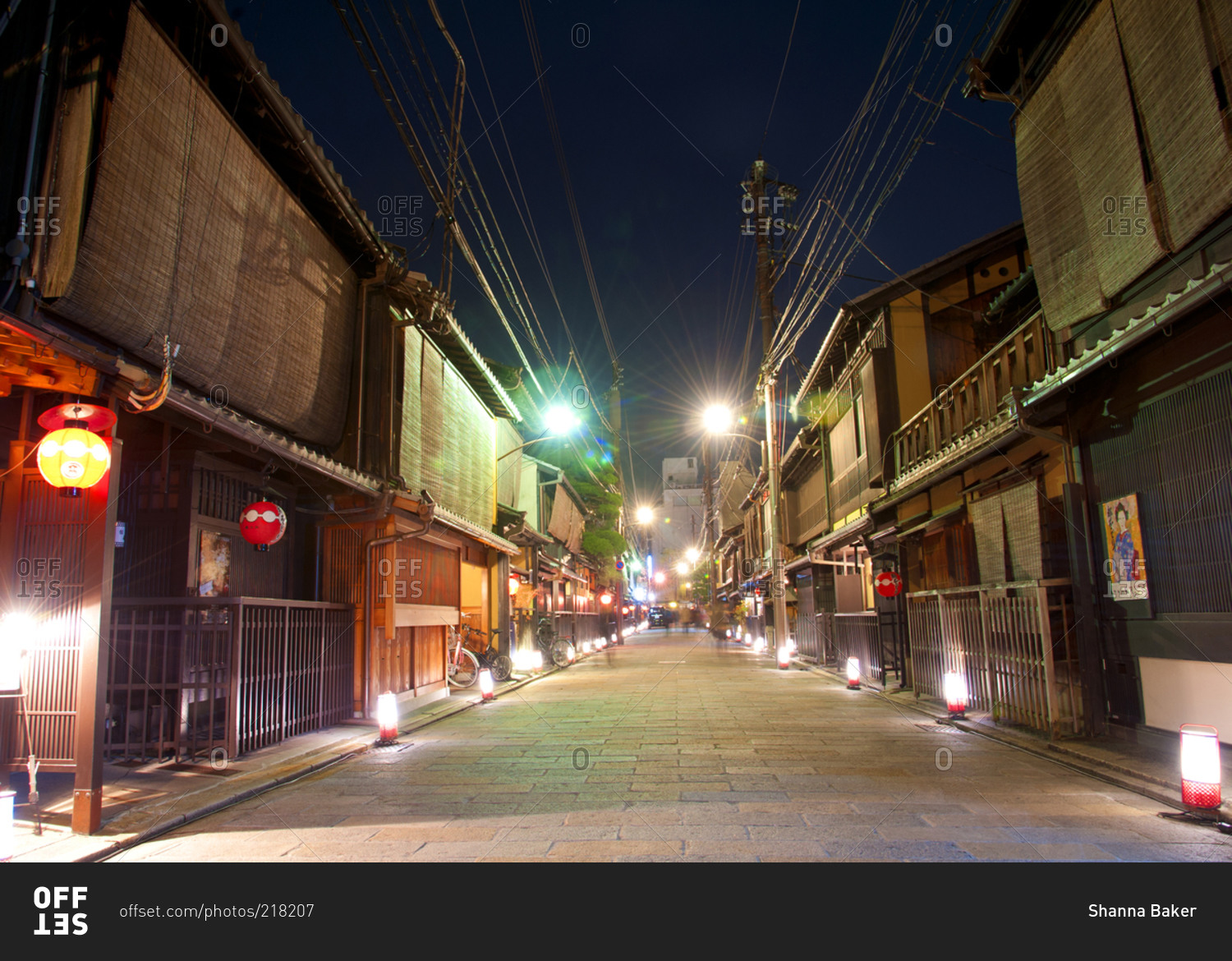 Brightly lit street scene at night in Kyoto