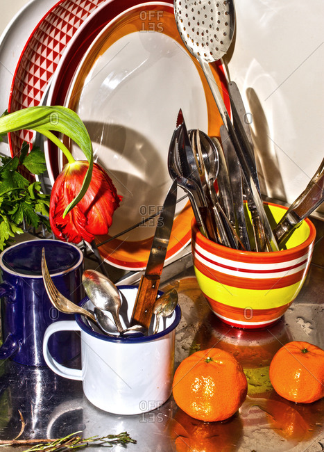 A kitchen countertop filled with utensils