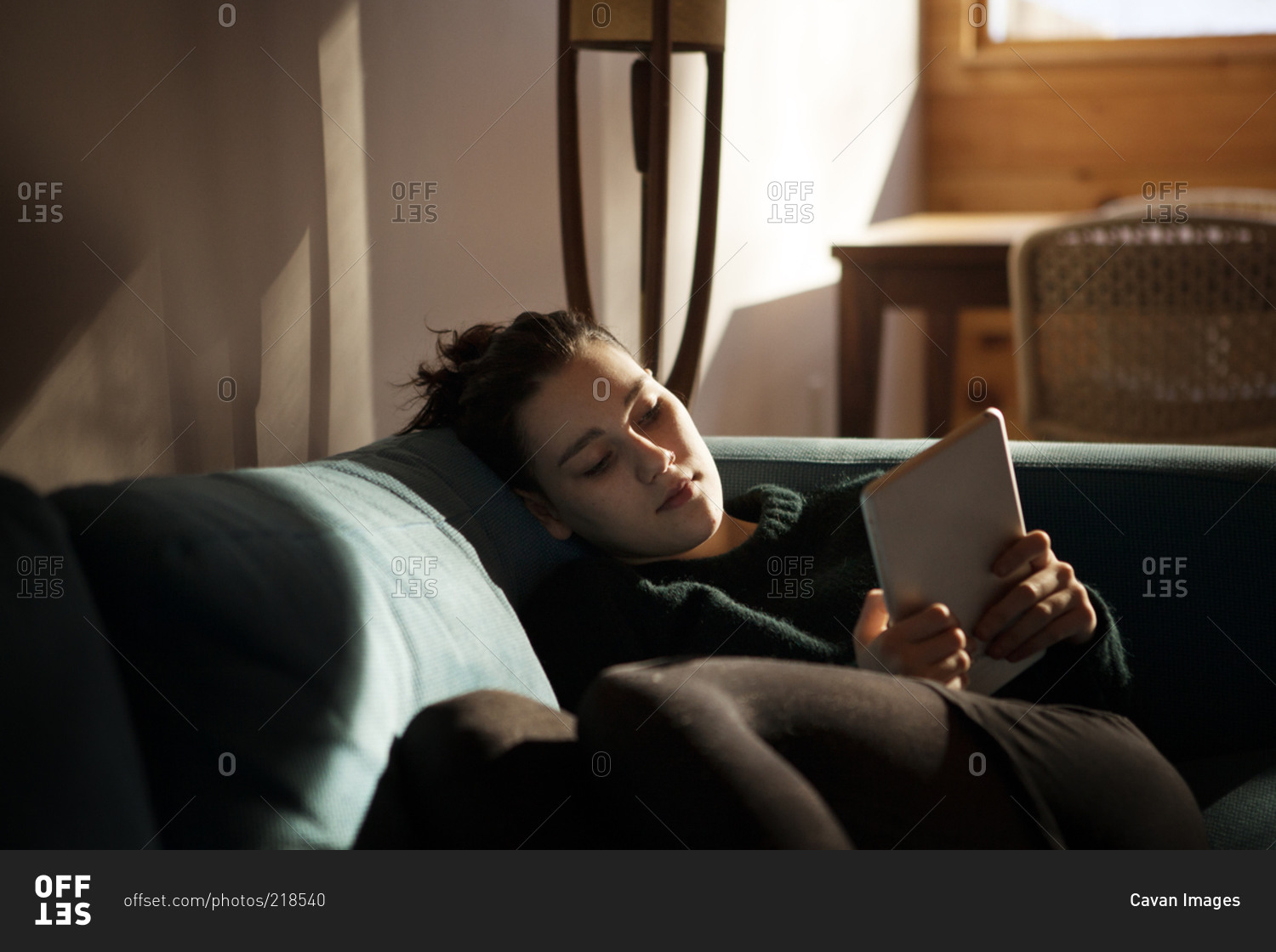 Girl Lounging On Couch Reading Tablet Stock Photo Offset