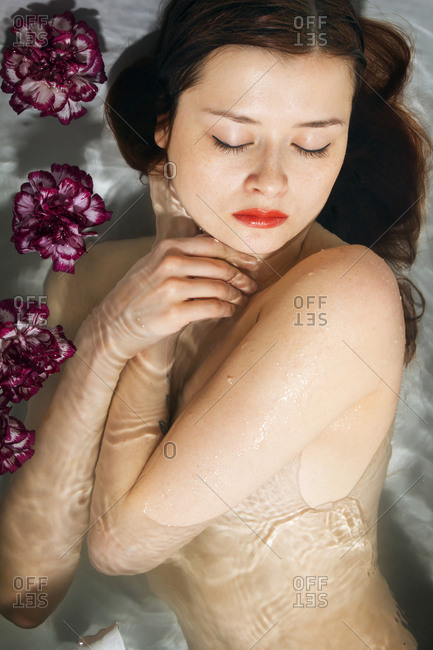Naked Woman Lying In Tub With Flowers Stock Photo Offset
