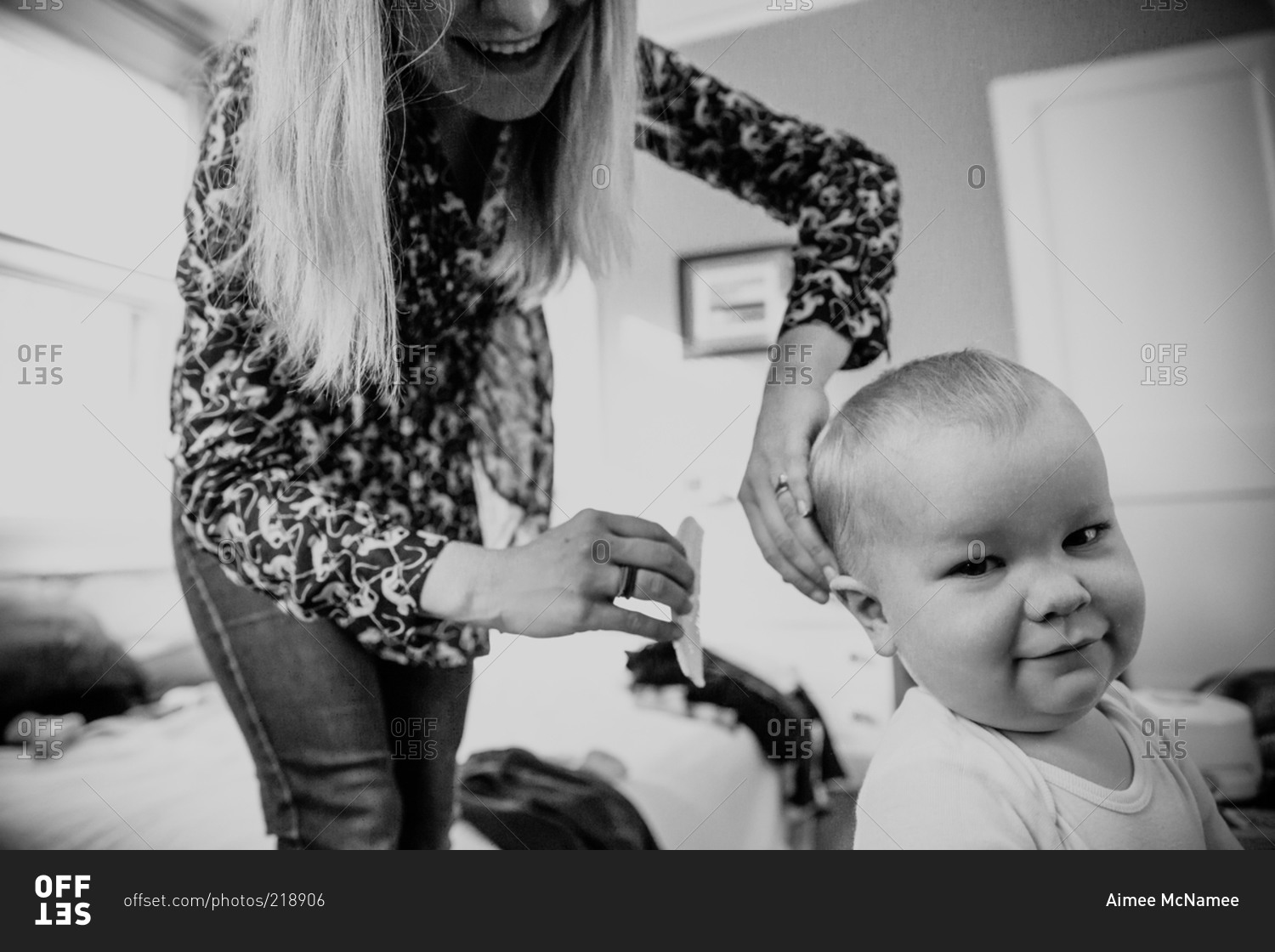 mother-combing-her-baby-s-hair-stock-photo-offset