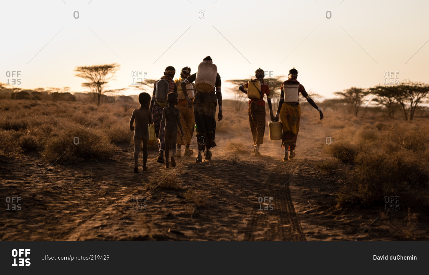 Families head home after fetching water from a borehole in Northern Kenya, Africa