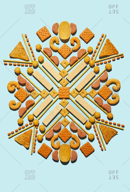 Assorted snacks arranged on blue background