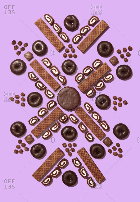 Chocolate-flavored snacks on pink background
