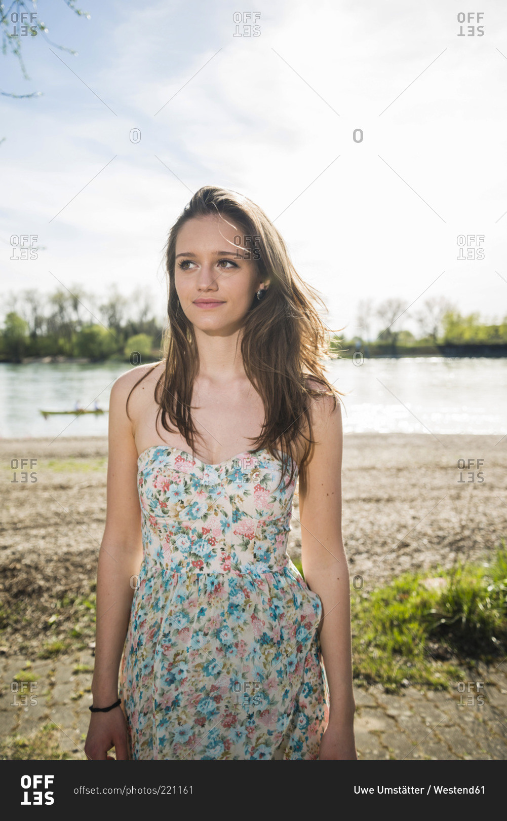 Young woman in summer dress standing at River Rhine, Mannheim