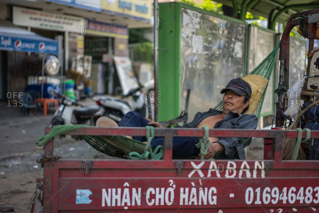 Saigon, Vietnam - November 17, 2014: Worker napping in hammock in Hoi An, Vietnam