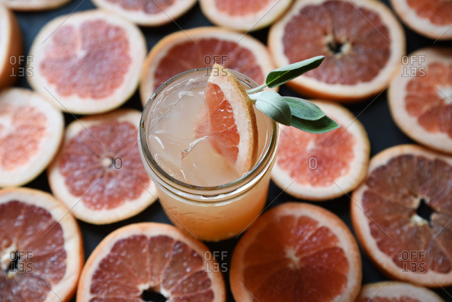 Fresh squeezed grapefruit juice on background of grapefruit slices