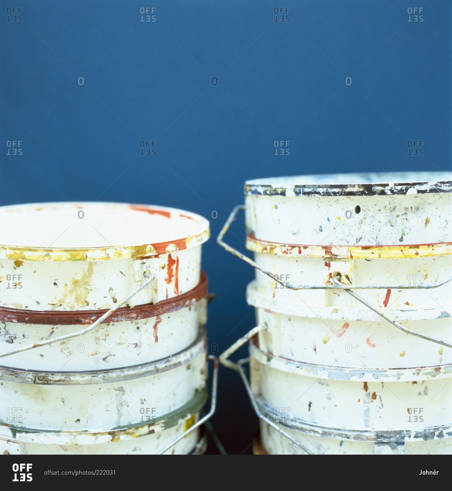 Empty paint buckets stacked against a wall stock photo OFFSET