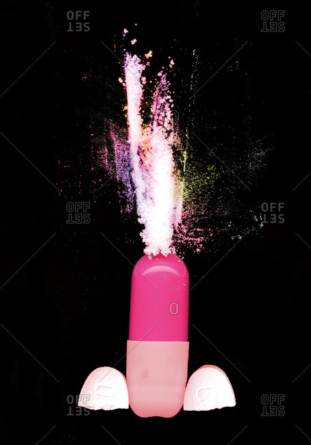 Powder erupting from a capsule